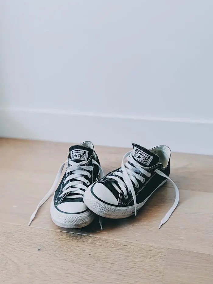 Converse All Star Low Top Sneakers On Brown Wooden Surface